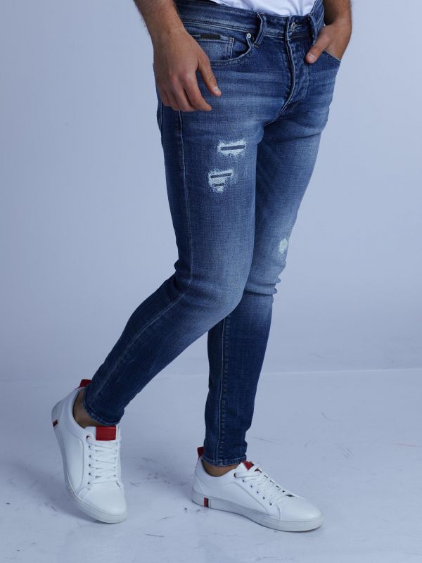 סקיני ג’ינס כחול משופשף עם קרעים